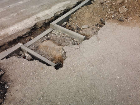 Pedestrian crossing repairment in Russia. New curbstone mounted after old dismounted. Diagonal view. Making for borderless space for disabled people. Copy-space.の写真素材