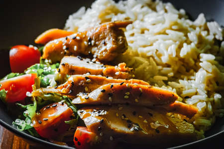 Indian curry spacy food. Chicken breast on basmati rice with vegetables.の写真素材