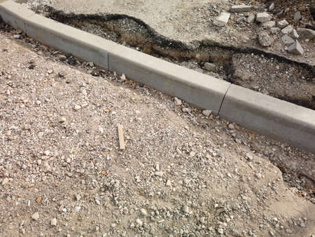 Road reconstruction renovation. New curbstone installed and ready to be fixed with concrete, copyspace.の写真素材