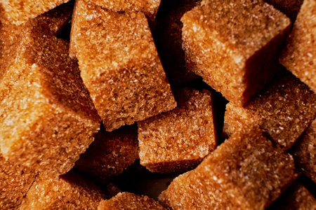 Organic brown sugar cubes macro background. Demerara sugar cubes.
