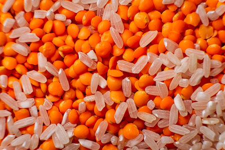 Red lentils and white rice mixed together macro food background.の写真素材