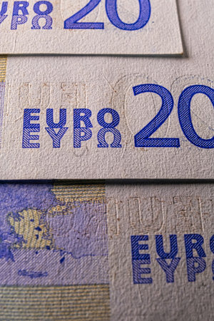 This is a twenty euro note macro image of a blue color banknote. The note has the European Union symbol on it, along with other symbols that represent economics.の写真素材