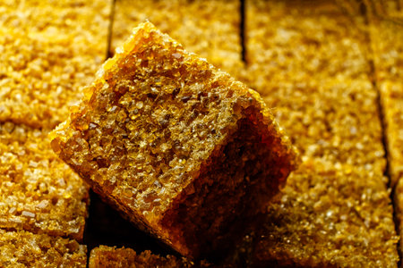 Brown sugar cube macro image. Sugar cube on top of other cubes in pack.の写真素材