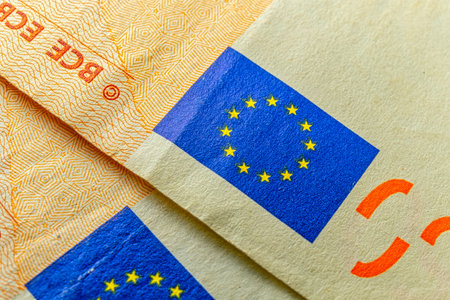 EU flag on euro banknote macro image.の写真素材