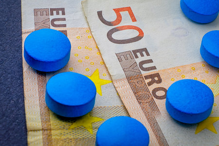 Herbal drug set of blue pill on 50 euro banknote macro.の写真素材