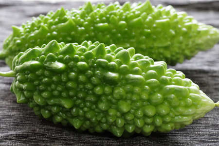 Bitter melon. Momordica charantia (coloquity: bitter melon;  bitter squash) is tropical and subtropical vine of the family Cucurbitiae, widely grown in Asia, Africa, and the Caribbean.の写真素材
