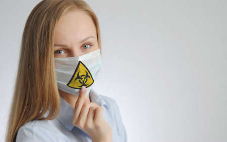 young woman in medical mask with virus sign print. health protection during the epidemic concept