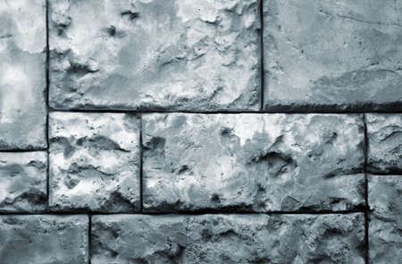 background with brick wall of stones. Cracks and scratches close up