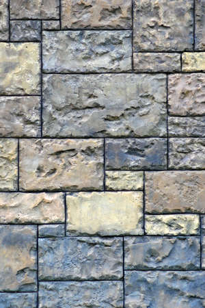 Gothic background with brick wall of stones. Cracks and scratches close up