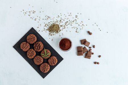 CBD cookies, cannabis chocolate, cocoa and hemp seed on bright background. Medicinal marijuana in food.の写真素材