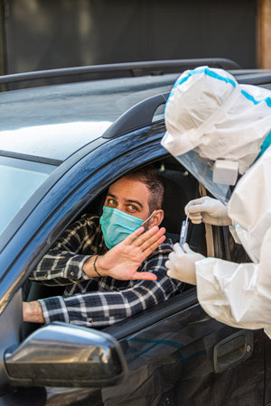 Man refuses medical worker trying to perform drive-thru COVID-19 test, taking nasal swab sample from...