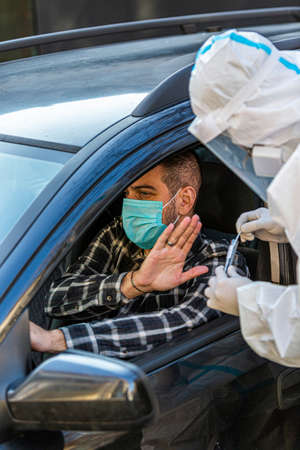 Man refuses medical worker trying to perform drive-thru COVID-19 test, taking nasal swab sample from...