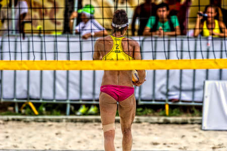 A USA Beach Volleyball Player is Walking Back to Get Ready to Serveのeditorial素材