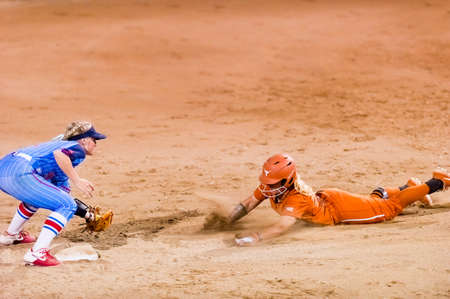 A Texas Longhorn Player Is Attempting A Stolen Base Against The Ole Miss rebels By Sliding Into Second Second Baseのeditorial素材