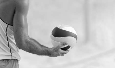 A Beach Volleyball Player Is Getting Ready To Serve the Ball In Black And White Image Formatの写真素材