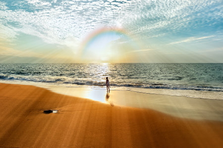 A Girl Is Looking At A Rainbow Arching Over The Oceanの写真素材