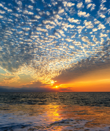 Ocean Sunset With A Colorful Cloudscape In A Blue And Orange Skyの写真素材