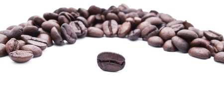 Fresh roasted coffee beans in the ring isolated on whiteの写真素材