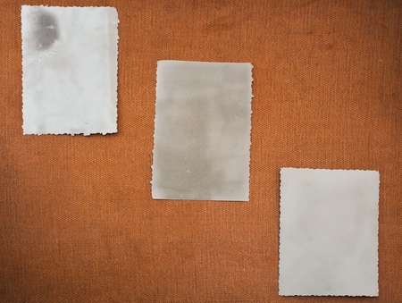 Three reverse of old photos on vintage background の写真素材