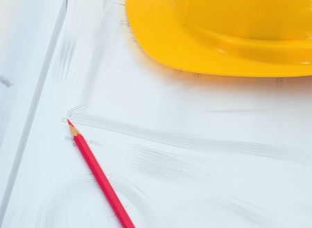 Construction plan with yellow helmet and red pencilの写真素材
