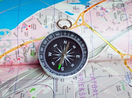 Compass on the map of city