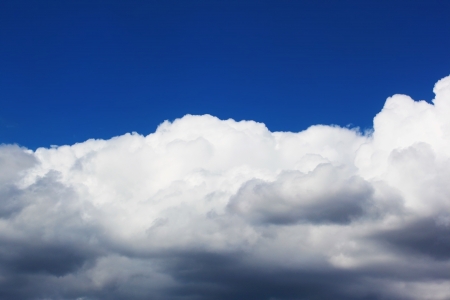 Huge stormy cloud over blue skyの写真素材