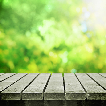 Wooden table near spring meadowの写真素材