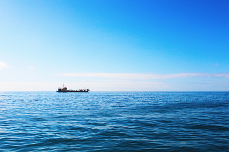 CArgo ship in ocean on sunny dayの写真素材