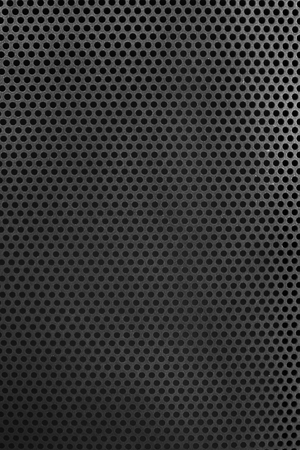 Holed dark metal surfaceの写真素材