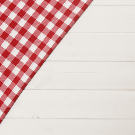 Red checkered tablecloth on wooden surfaceの写真素材