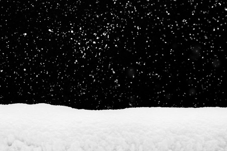 Snowdrift  and flying snow isolated over black, winter seasonの写真素材
