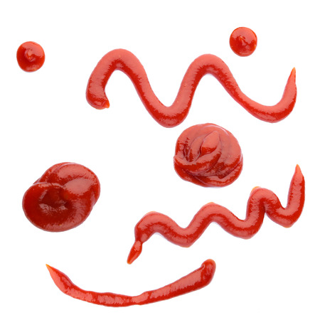 Red ketchup slashed on white, veiw from topの写真素材