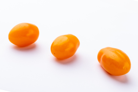 Three yellow tomatoesの写真素材