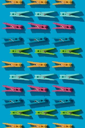 Clothes pins as pattern on blue backgroundの写真素材