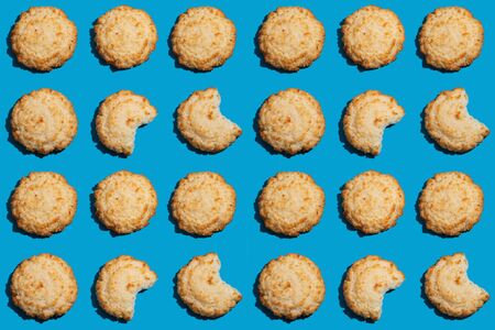 Bitten coconut cookies as pattern backgroundの写真素材