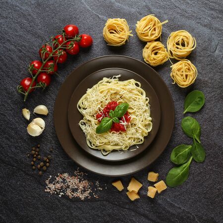 Prepared fresh pasta on a plate with ingredientsの写真素材