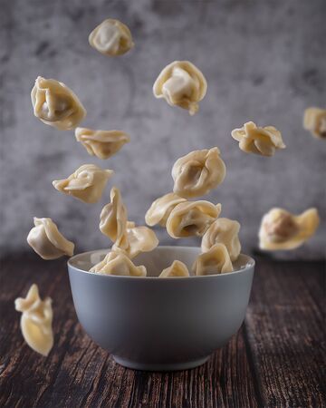 Levitation of cooked dumpling that flying in the bowlの写真素材