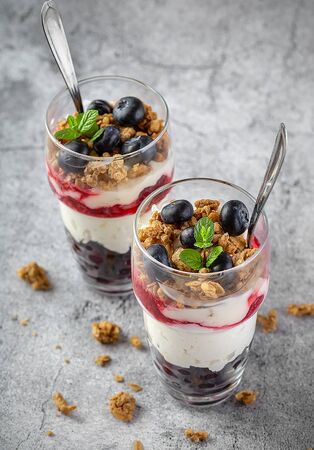 Two muesli glasses with granola and blueberryの写真素材