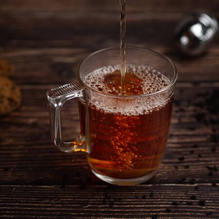 Splash of hot  tea in a cupの写真素材