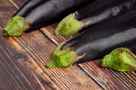 Fresh eggplants on the wooden tableの写真素材