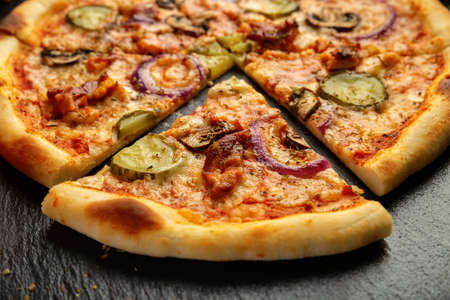 Pizza with ham, cucumber and onionの写真素材