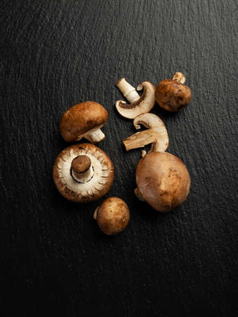 Some edible mushrooms on slate, top viewの写真素材