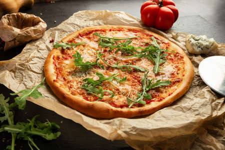 Cheese pizza with rucola and some ingredientsの写真素材