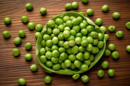 Green peas in a bowl on wooden background. Selective focus.の素材