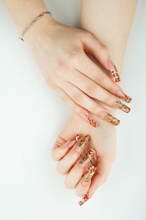 Woman hand closeup with beautiful manicure on white backgroundの写真素材