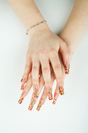 Woman hand closeup with beautiful manicure on white backgroundの写真素材