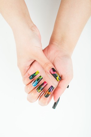 Woman hand closeup with beautiful manicure on white backgroundの写真素材