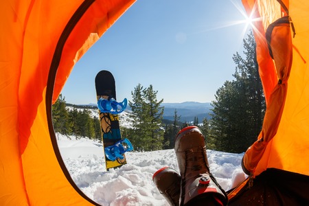 Snowboarder lies in tentの写真素材