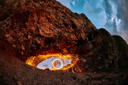 eyes are painted burning steel wool in the mountainの写真素材