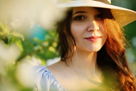 Portrait of a girl in a flowering garden